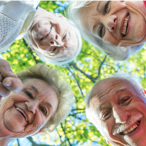 Four old age people smiling for a picture